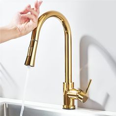 a person is washing their hands under a faucet