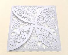 a white paper cutout with an intricate design