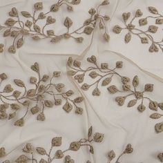 an embroidered fabric with leaves on it