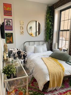 a bed sitting next to a window in a room with a rug on the floor