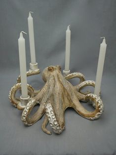 an octopus candle holder with five candles in it