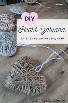 diy heart garland made out of yarn and twine on a wooden table with text overlay that says diy heart garland an easy valentine's day craft