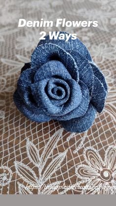 a blue flower sitting on top of a lace covered table cloth with the words denim flowers 2 ways