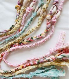 there are many different types of braids on the table together, including one with seashells