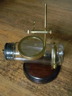 an old fashioned magnifying glass on top of a wooden table