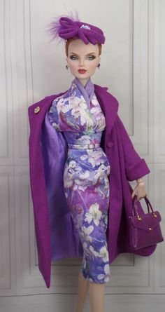 a barbie doll wearing a purple kimono and carrying a handbag in her left hand