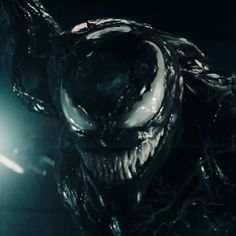 an alien creature in the dark with its mouth open