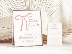 a wedding stationery with a pink ribbon on it