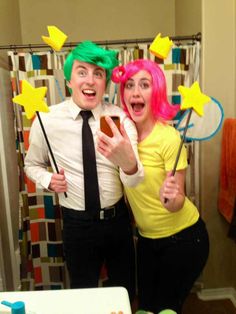 two people dressed in wigs posing for a photo