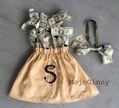 a dress made out of dollar bills with the letter s on it