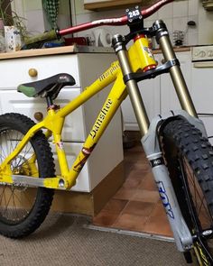 a yellow mountain bike parked in a kitchen