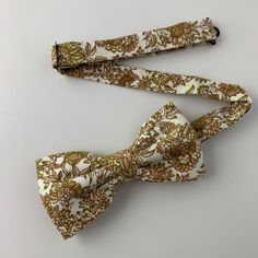 This handmade floral tie is an excellent accessory for weddings, parties, proms - an excellent gift for anyone who enjoys dressing-up dapper! Style: Slim/narrow Fabric: 100% cotton Approx. Measurements: (W) 2.4 in. x (L) 58 in. Dry clean only Matching Men's Bow Tie Style: Pre-tied (w/ adjustable straps) Fabric: 100% cotton Size: Mens | One size Bow measures approx. 4.75 in. x 2.4 in. Dry clean only Matching Pocket Square Fabric: 100% cotton Approx. 12 in. x 12 in. Dry clean only Thank you! Square Fabric, Groomsmen Ties, Groomsman Gift, Dapper Style, Floral Pocket, Wedding Flower Decorations, Tie Styles, Mens Bow Ties, Party Style