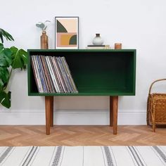 a record player sitting on top of a green shelf