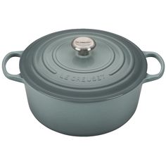 a blue casserole with a metal lid