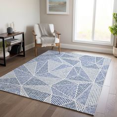 a living room with a blue rug and chair