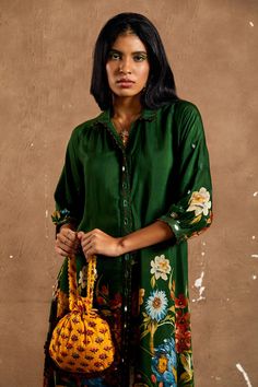 Bottle green silk voile floral printed shirt style tunic with mirror work placket and sleeves. Paired with pant.
Component: 2
Pattern: Print and Embroidery
Type Of Work: Floral Print, Mirror Work Embroidery
Neckline: Shirt Collar
Sleeve Type: Puff
Fabric: Silk Voile
Color: Green
Other Details: 
Floral print
Mirror embroidery detailing
Note: The potli bag and neckpiece shown in the images is not for sale
Occasion: Mehendi and Haldi - Aza Fashions Green Floral Embroidery Tunic, Green Silk Blouse With Floral Print, Green Long Sleeve Tunic With Printed Motifs, Green Floral Embroidered Tunic For Spring, Green Long Sleeve Tunic With Floral Print, Green Long Sleeve Tunic With Floral Embroidery, Green Floral Print Long Sleeve Tunic, Green Printed Blouse For Daywear, Silk Tunic With Printed Motifs For Spring