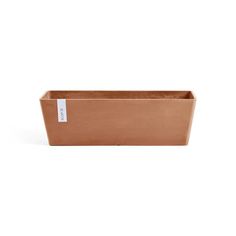 a copper rectangular planter with a white label on the front and back side of it