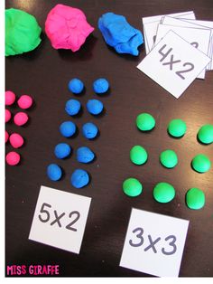 the table is covered with different colored candies and numbers for each individual to use