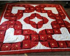 a red and white quilt on the ground