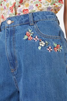 Embroidered denim short featuring sweet flower embroidery around the pockets, high waisted fit & made of cotton - length finishes mid thigh- wide cut leg shape- handy side and back pockets- sweet flower embroidery placements on front and back- front fly & button opening- made from a mid-weight cotton denim- available in mid denim Product Code: PGFY274 High Waist Denim Bottoms With Floral Embroidery, Short Denim Jeans With Floral Embroidery, High Waist Cotton Jean Shorts With Floral Embroidery, Trendy Short Jeans With Floral Embroidery, Trendy Short Floral Embroidered Jeans, Denim Blue Cotton Shorts With Floral Embroidery, Spring High Rise Shorts With Floral Embroidery, Spring High Rise Floral Embroidery Shorts, High Rise Floral Embroidery Shorts For Spring