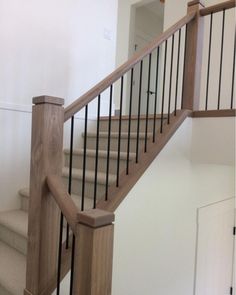 a wooden stair case next to a white door