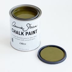 a can of olive green chalk paint next to an empty tin with the lid open