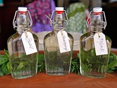 three empty glass bottles with labels on them