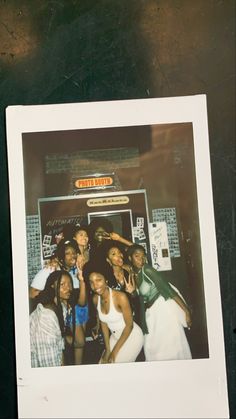 a group of young women standing next to each other in front of a store window