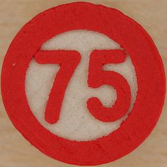 a close up of a red and white circle with the number 75 in it's center