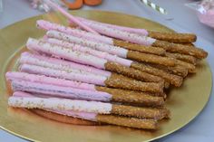 there are many pretzels on the plate with pink and white frosting in them