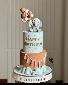 a birthday cake with an elephant on top