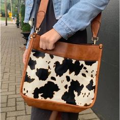 Brown And Cow Print Saddle Crossbody Bag Purse This Bag Measures 10.25 Inches Tall And 12 Inches Across With 3 Inch Width On The Sides. Adjustable Matching Strap And Gold Hardware. Interior Has 2 Open Pockets And 1 Zippered Pocket. Purse Has Zipper Closure. Vegan Leather Brown Satchel With Snap Closure For On-the-go, Brown Casual Satchel With Snap Closure, Casual Brown Satchel With Snap Closure, Brown Tote Shoulder Bag With Snap Closure, Chic Brown Hobo Bag With Snap Closure, Casual Brown Crossbody Hobo Bag, Snap Closure Crossbody Hobo Bag, Casual Brown Shoulder Bag With Snap Closure, Brown Hobo Bag With Snap Closure For Everyday Use