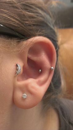 a close up of a person with ear piercings on their left and right ears