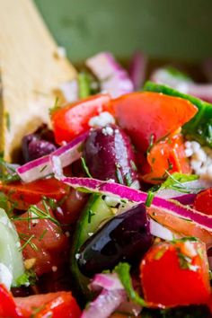 a salad with carrots, cucumbers, red onions and feta cheese