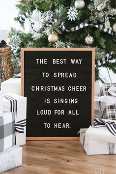 the best way to spread christmas cheer is singing loud for all to hear sign next to presents