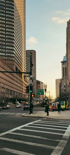 an intersection in the city with cars and pedestrians