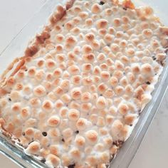 a casserole dish with marshmallows in it on a white table