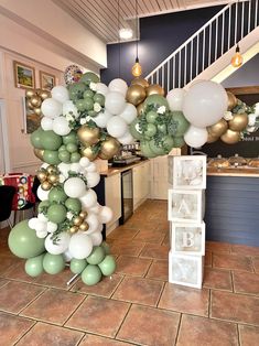 balloons and garlands are hanging from the ceiling in a room with tile flooring