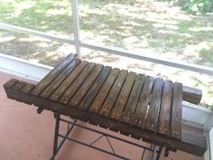 a wooden bench sitting in front of a window