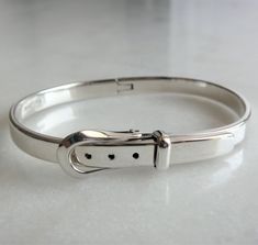 Bracelet made of noble material: 925/1000 solid silver. You will love the unique shape of this bracelet. Its design as a belt buckle brings a light, refined and sought after aspect. As a belt, this bracelet is adjustable. Internal circumference: from 17.5cm to 18.6cm (6.89in to 7.32in) Height: 6mm (0.24in) Weight: 28g (1oz) Production: handmade by our partner craftsman in Mexico.  Free shipping. Elegant Silver Cuff Bracelet With Box Clasp, Classic Adjustable Jewelry With Silver Buckle, Vintage Adjustable Silver Cuff Bracelet, Adjustable Hand-cast Silver Cuff Bracelet, Antique Silver Nickel-free Cuff Bracelet, Nickel-free Metal Vintage Bracelet, Mens Bracelet Set, Adjustable Silver Bracelet, Gemstone Cuff Bracelet