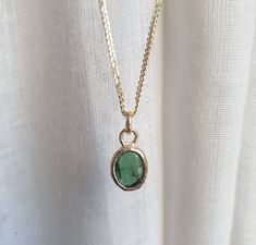 This minimalist Green Tourmaline, solid gold necklace was designed with a bottle green see through pendant, to beautifully accompany you through your busy days. The classic simple design is always pretty for day and evening, work or fun. The gold Tourmaline necklace is handmade and delicate and available both with a 9kt or a 14 karat pendant. The solid gold chain is made of 14k and available in a of couple lengths. The clear Green Tourmaline necklace is a perfect chic and elegant gift. The penda Green Pendant Necklace Gold, Minimalist Everyday Emerald Birthstone Necklace, Everyday Minimalist Emerald Birthstone Necklace, Minimalist Emerald Necklace With Round Pendant, Minimalist Emerald Birthstone Necklace With Round Pendant, Minimalist Emerald Pendant Necklace As Birthstone, Minimalist Emerald Pendant Necklace With Birthstone, Minimalist Yellow Gold Emerald Necklace For Gift, Minimalist Green Emerald Necklace For Everyday