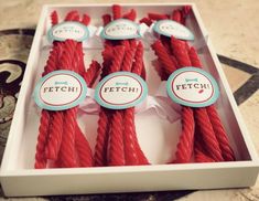 several red candles in a white box with labels on them that say fetch and fetch