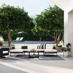 an outdoor patio with black and white furniture