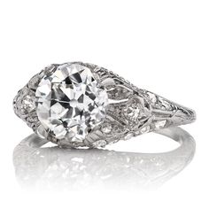 an antique style diamond ring with filigrees