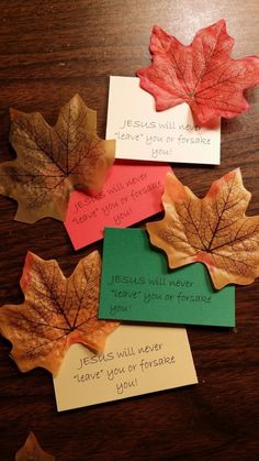 four leaf cards with words written on them