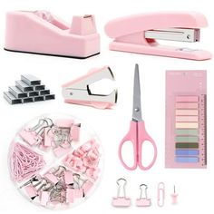 pink crafting supplies including scissors, paper clips and stapler