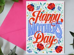 a card with the words happy mother's day on it next to some flowers