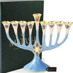 a hanukkah menorah is shown in front of a boxed book