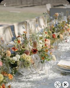 an image of a table setting with flowers and wineglasses on the long table