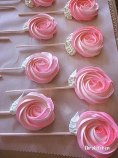 pink and white cupcakes are on a tray